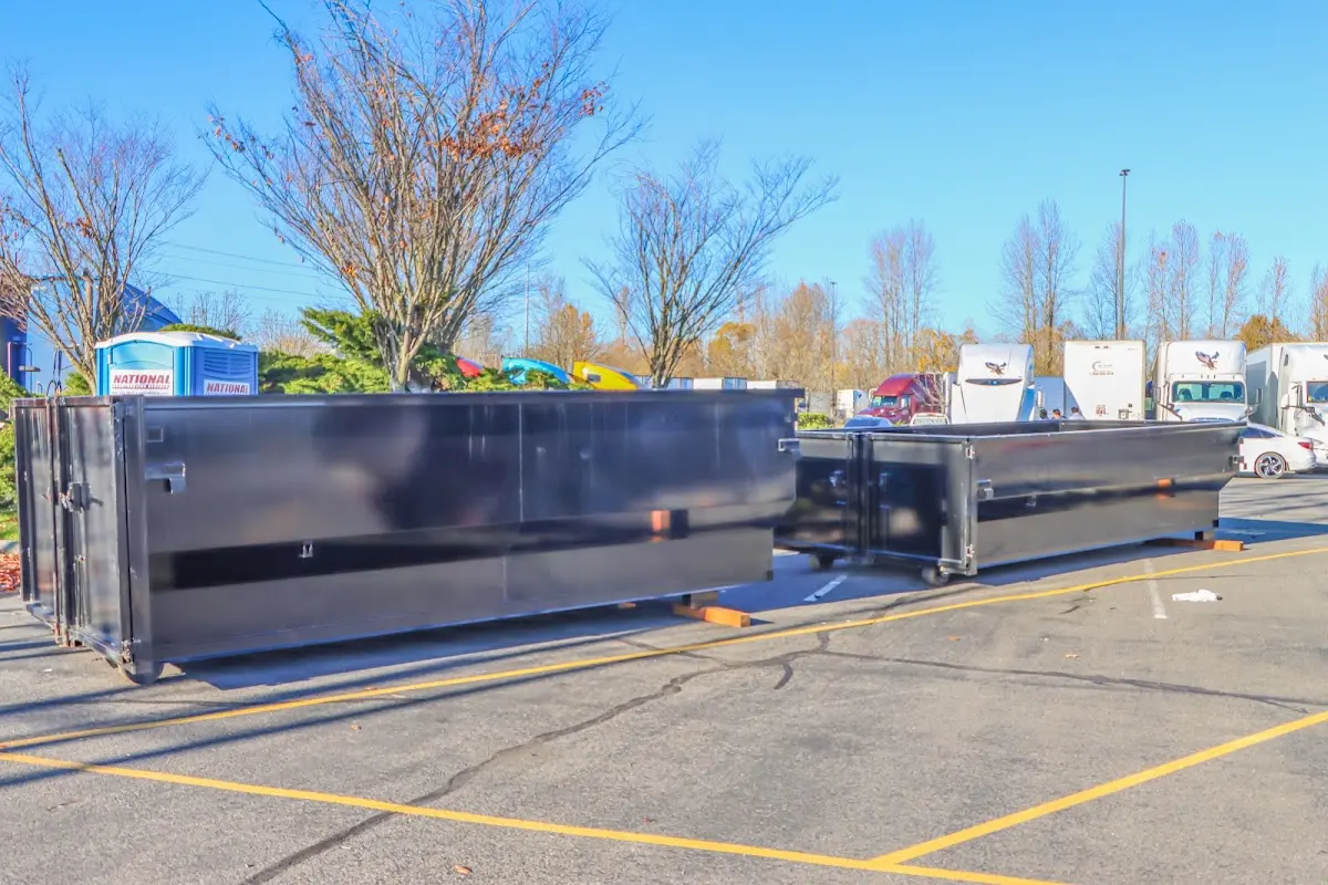 Professional dumpster rental service with roll-off container on residential driveway in Maili